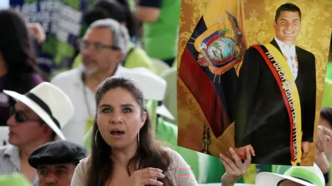 Reuters A supporter of Ecuador's former President Rafael Correa holds a poster during a convention of the Alianza Pais party in Esmeraldas, Ecuador, on 3 December 2017