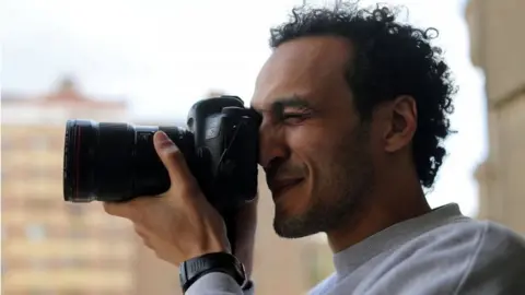 Reuters Egyptian award-winning photographer Mahmoud Abu Zeid, also known as Shawkan, takes pictures after his release, at his home in Cairo, Egypt, on 4 March 2019.