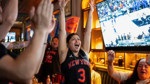REUTERS/Christian Monterrosa Fans gather at a watch party at Stout NYC sports bar near Madison Square Garden on the day of Game 5 of the NBA Finals between the New York Knicks and San Antonio Spurs, in New York City, U.S., June 13, 2026. 
