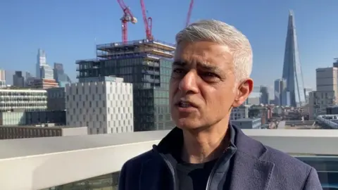 LDRS Mayor of London Sadiq Khan speaking in Southwark, on a sunny day with London landmarks in the background