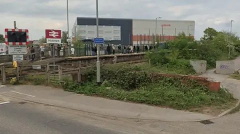 Google Hykeham station. It is an open station, next to a level crossing. 