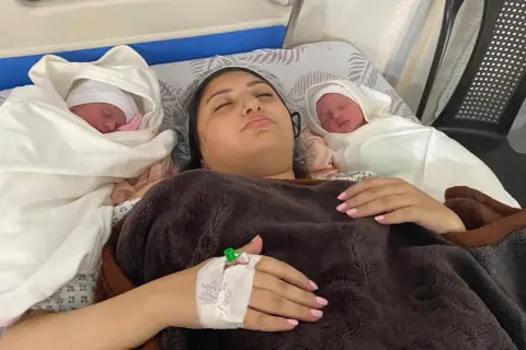 Family handout Jomana Arafa lies in hospital after giving birth to her twins, Aysal and Asser