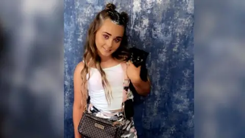 Perri-Leigh Littler A young girl with long blonde hair smiling at the camera.