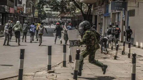 Police officers are seen during the clashes between protesters and security forces as people stage a protest to commemorate the victims of "Finance Bill 2024" protests in Nairobi, Kenya on June 25, 2025.