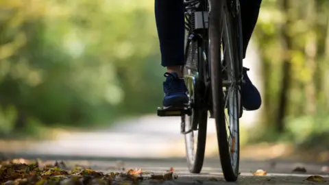 Person riding a bicycle along 