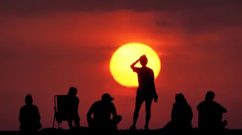 PA Media People turning out to watch the sunrise at Cullercoats Bay, North Tyneside