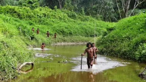 Archaeological Survey of India Members of the Shompen tribe walking on a river in Great Nicobar Island