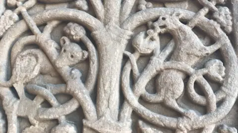 An ornately carved stone panel found at Jedburgh in the Scottish Borders, which most likely formed the gable end of an enclosed shrine or sarcophagus (stone coffin) dating from the early 700s