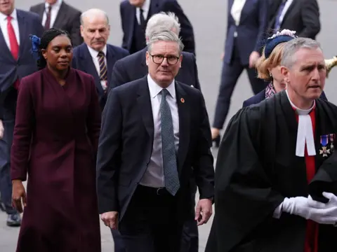 Jonathan Brady/PA Media Prime Minister Sir Keir Starmer, followed by Conservative Party leader Kemi Badenoch, arrive to attend a Service of Thanksgiving at Westminster Abbey in London on the 80th anniversary of VE Day. Picture date: Thursday May 8, 2025.