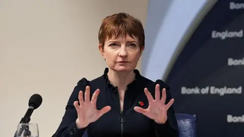Getty Images Bank of England deputy governor Clare Lombardelli addresses a press conference and gesticulates with both hands as she speaks.