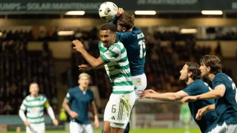 Motherwell's Sam Nicholson jumps with Celtic's Aaron Trusty