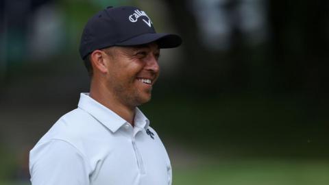 Xander Schauffele smiles while playing at the US PGA Championship