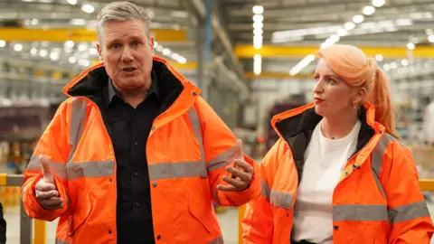 PA Media Keir Starmer and Louise Haigh wearing high vis jackets 