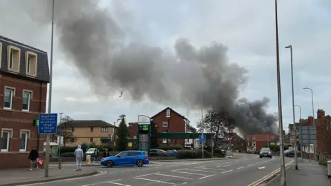 Steve Gould A street in Skegness with plumes of black smoke from the fire in the background.