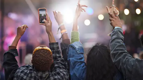 Getty People pictured enjoying themselves at a festival 