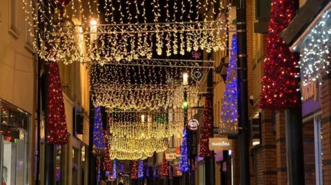 DOUGLAS COUCIL Gold red and purple lights along Strand Street.
