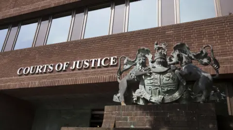 The front of Portsmouth Crown Court, with the words 'Courts of Justice' on the wall. 