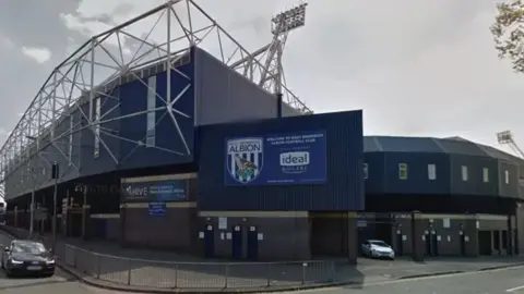 Getty Images A side view of The Hawthorns ground in West Bromwich. The ground's blue decor can be seen with an entrance on the right hand side.