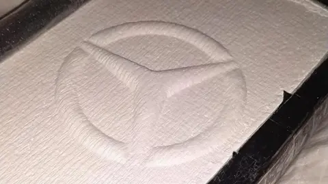 South Wales Police A large brick of cocaine with the Mercedes badge embossed on top.