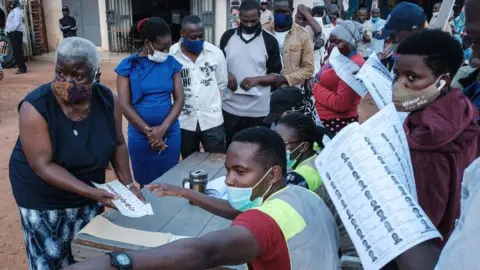 AFP Voters lining up at a polling station in Kampala, Uganda.