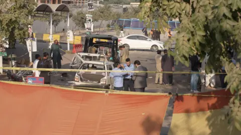 Police in Islamabad stand behind a corden after a suicide bomber blew up a car in Pakistan's capital city