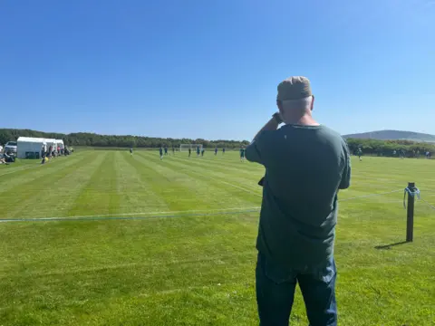 Steve Broughton watching the Isle of Man vc Hitra football match in Firth, Orkney