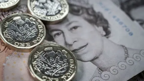 Getty Images New one pound coin and ten pound note