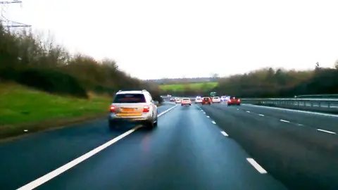 Thames Valley Police An image of a speeding car driving on the hard shoulder of the motorway