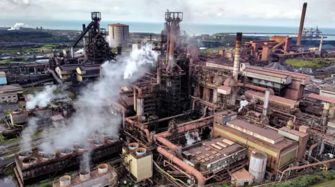 PA Media The Port Talbot steelworks with smoke coming out of the furnaces