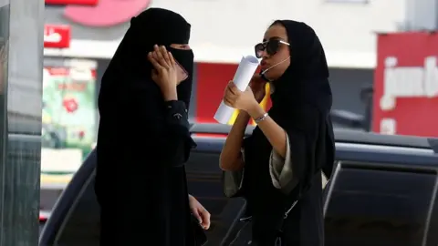 Reuters Saudi women speak on phones in Riyadh, Saudi Arabia (27 September 2017)