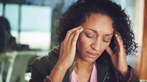 Getty Images Woman with migraine