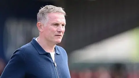 Phil Parkinson looks on from the touchline at Lincoln City