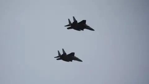 Two of South Korean Air Force's F-15K fighter jets flying during a celebration to mark 76th anniversary of Korea Armed Forces Day in Seongnam in 2024