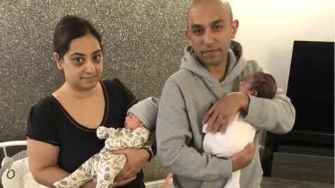 BBC Manisha and Metaish Parmar holding their two babies