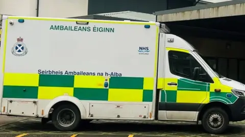 Ambulance with green and yellow checked markings