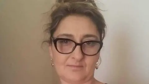A portrait Izabela Chalastra wearing glasses.