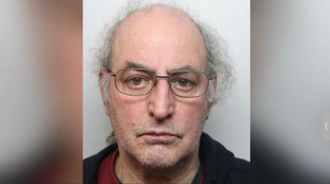 Police mugshot of James Hemphill with untidy grey hair
