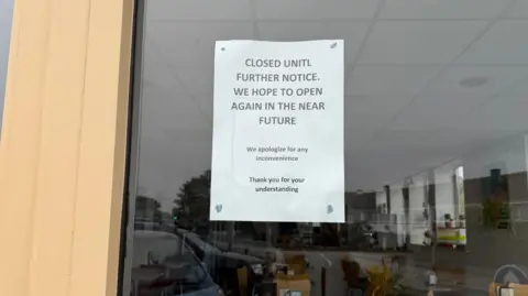 A picture of a sign on the Bean Café saying that its closed till further notice