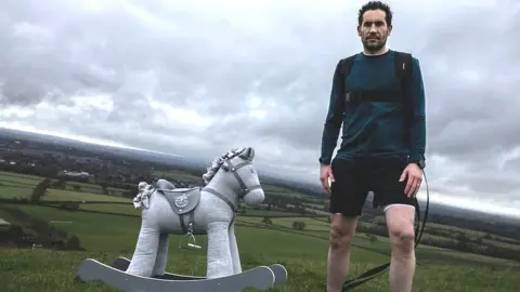 Josh Braid with the rocking horse he will be taking to the South Pole