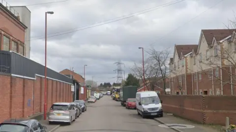 Google Industrial and residential street with cars parked on both sides