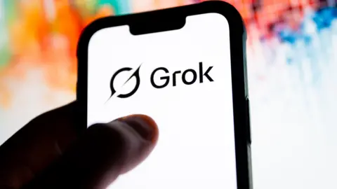 A phone with the Grok logo on it and a colourful background
