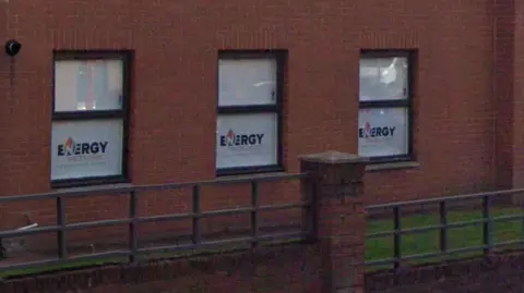 A red brick building with tinted windows saying Energy Prices Direct Limited on them