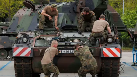 Getty Images Mechanic soldiers of the Bundeswehr, the German armed forces are seen as they service a Panzerhaubitze 2000