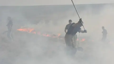 West Yorkshire Fire and Rescue Service Firefighters fighting moorland fire