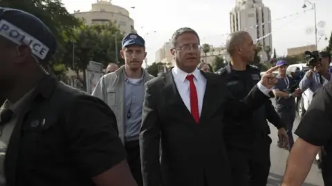 EPA Itamar Ben-Gvir with his security detail during the Pride march