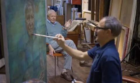 Jonathan Yeo Studio A photo of Jonathan Yeo painting Sir David Attenborough