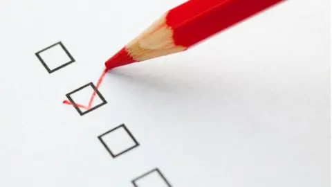 Getty Images Picture of a red pencil ticking a box