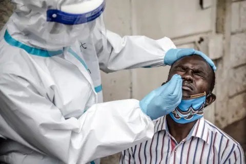 AFP A man gets a nasal swab in Kenya