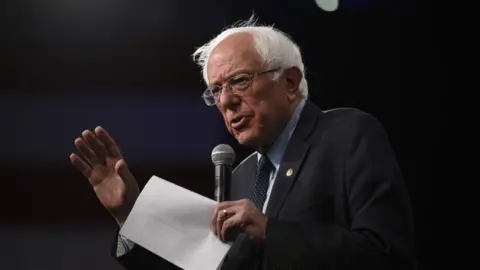 Getty Images Democratic presidential candidate Sen. Bernie Sanders speaks on stage during a forum on gun safety at the Iowa Events Center on August 10 2019