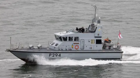 The HMS Trumpeter is pictured sailing with a crew on board. 